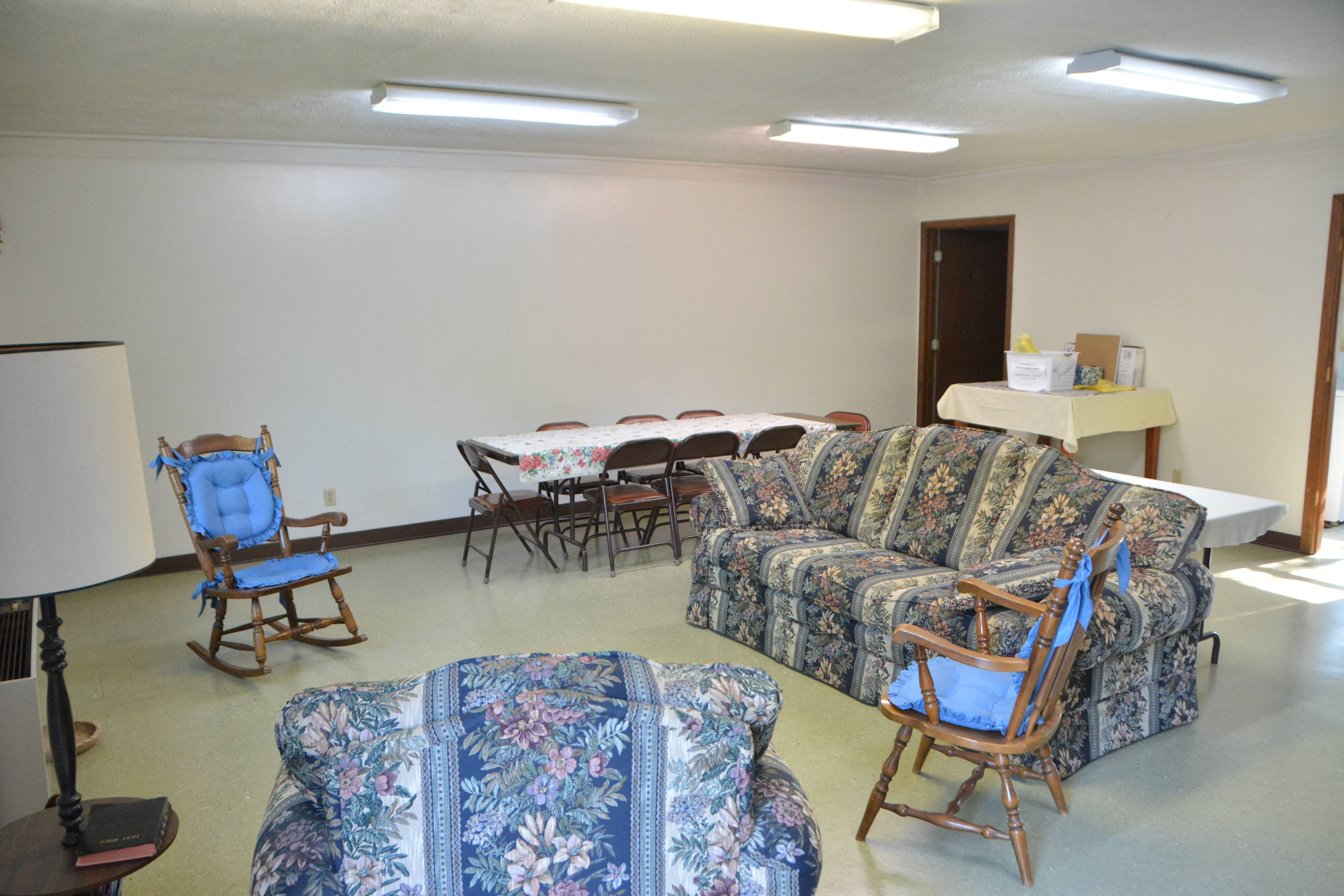 a living room with furniture and a table with chairs